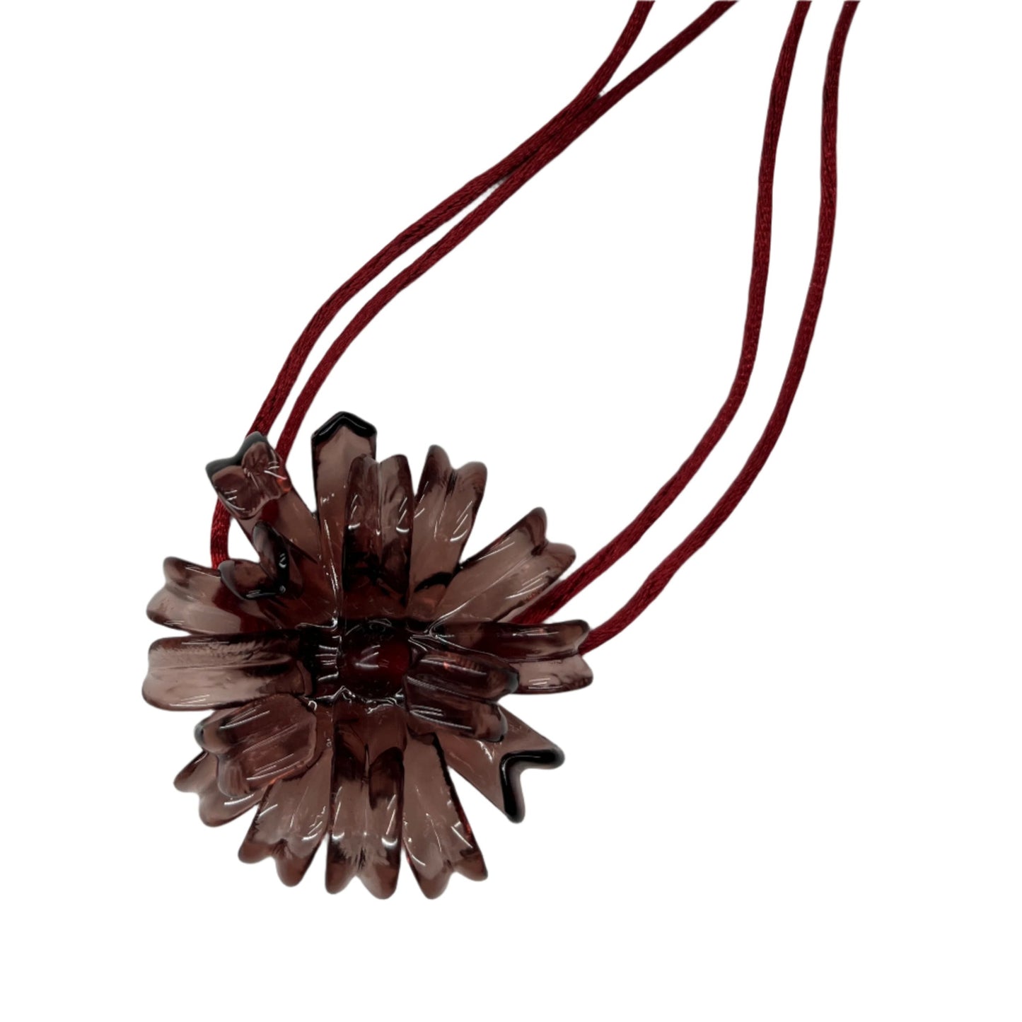 Brown flower-shaped pendant on a red cord against a white background