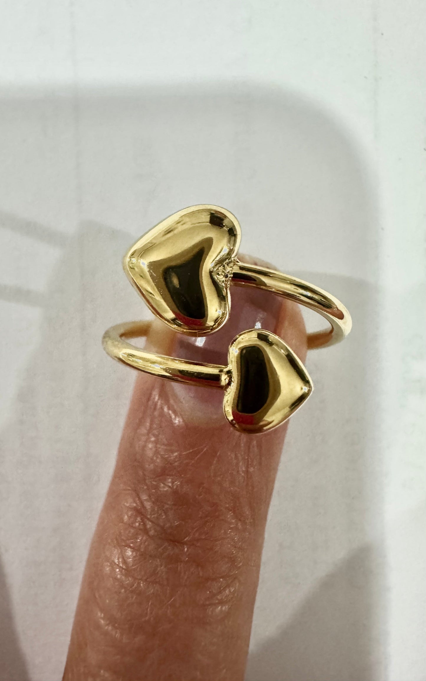 Heart Ring - close-up detail showing adjustable band and heart design
Gold heart-shaped ring on a finger against a neutral background