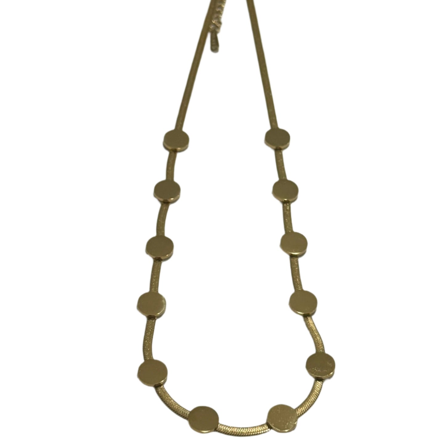 Gold belt with circular studs on a light gray background
Essence Stich Necklace worn - Model wearing circular pendant necklace
