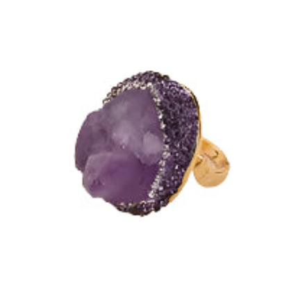 Purple stone ring with gold band on a white background
