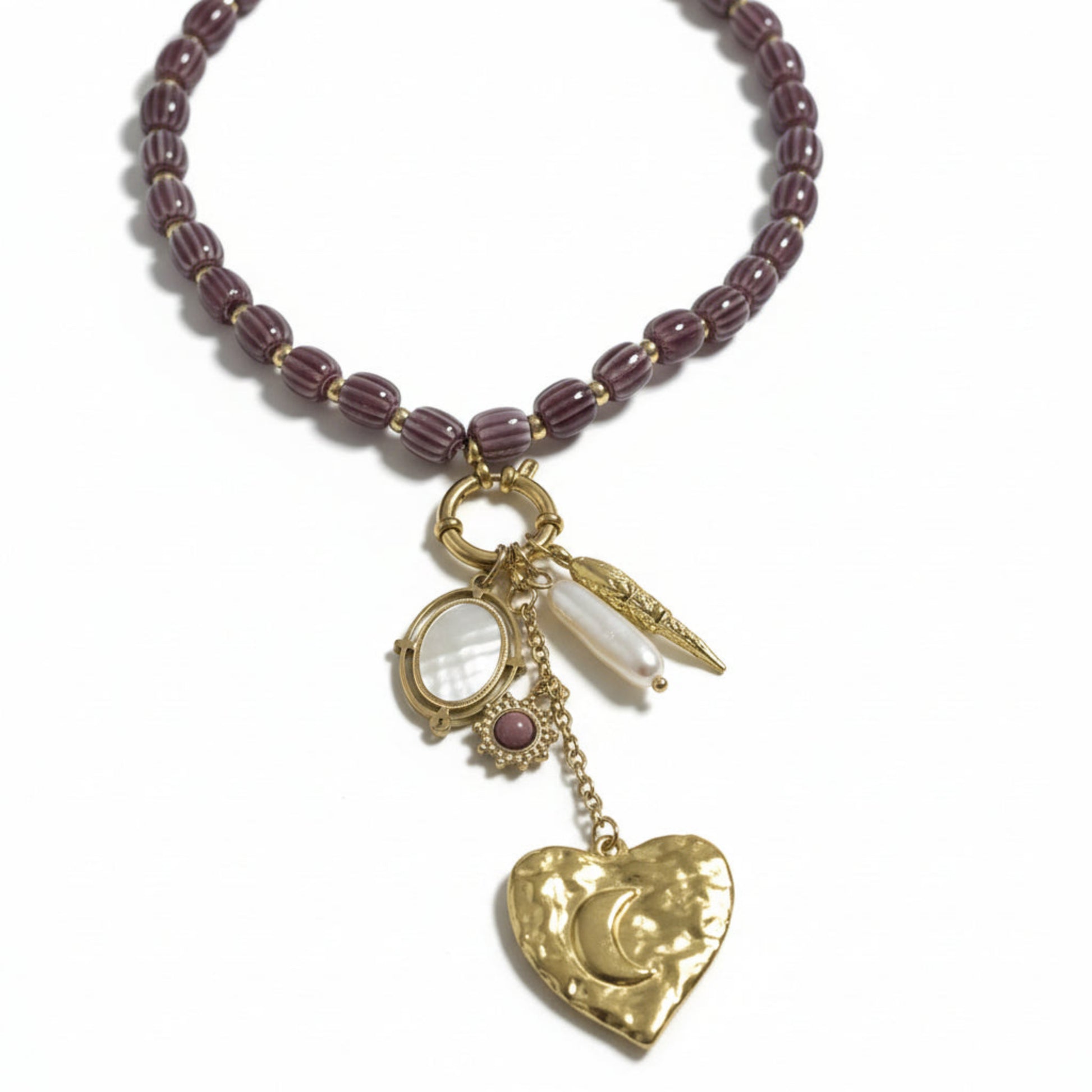 Golden Star necklace with heart charm and purple beads, flat lay detail