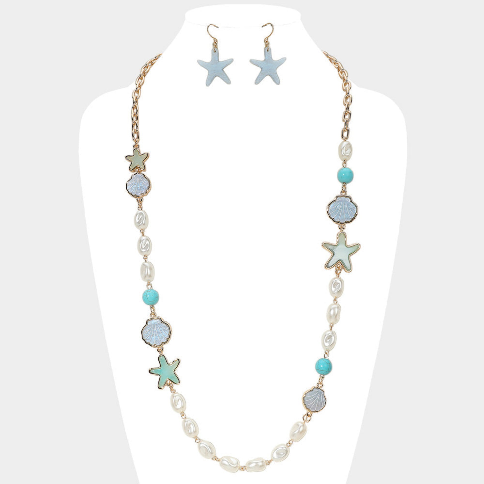 Eternal Star Necklace - delicate star pendant necklace by SIETE Y UNO
Necklace and earrings with starfish and turquoise accents on a mannequin.