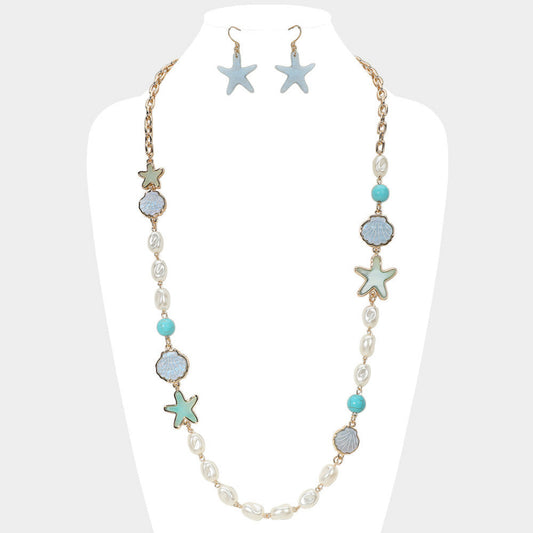 Eternal Star Necklace - delicate star pendant necklace by SIETE Y UNO
Necklace and earrings with starfish and turquoise accents on a mannequin.