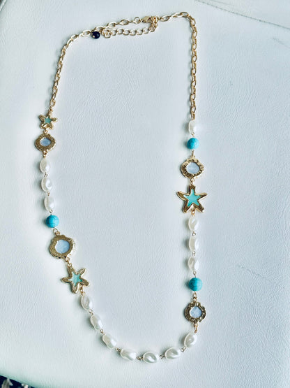 Eternal Star Necklace - close-up detail of star charm and chain
Necklace with star-shaped and circular beads on a white background