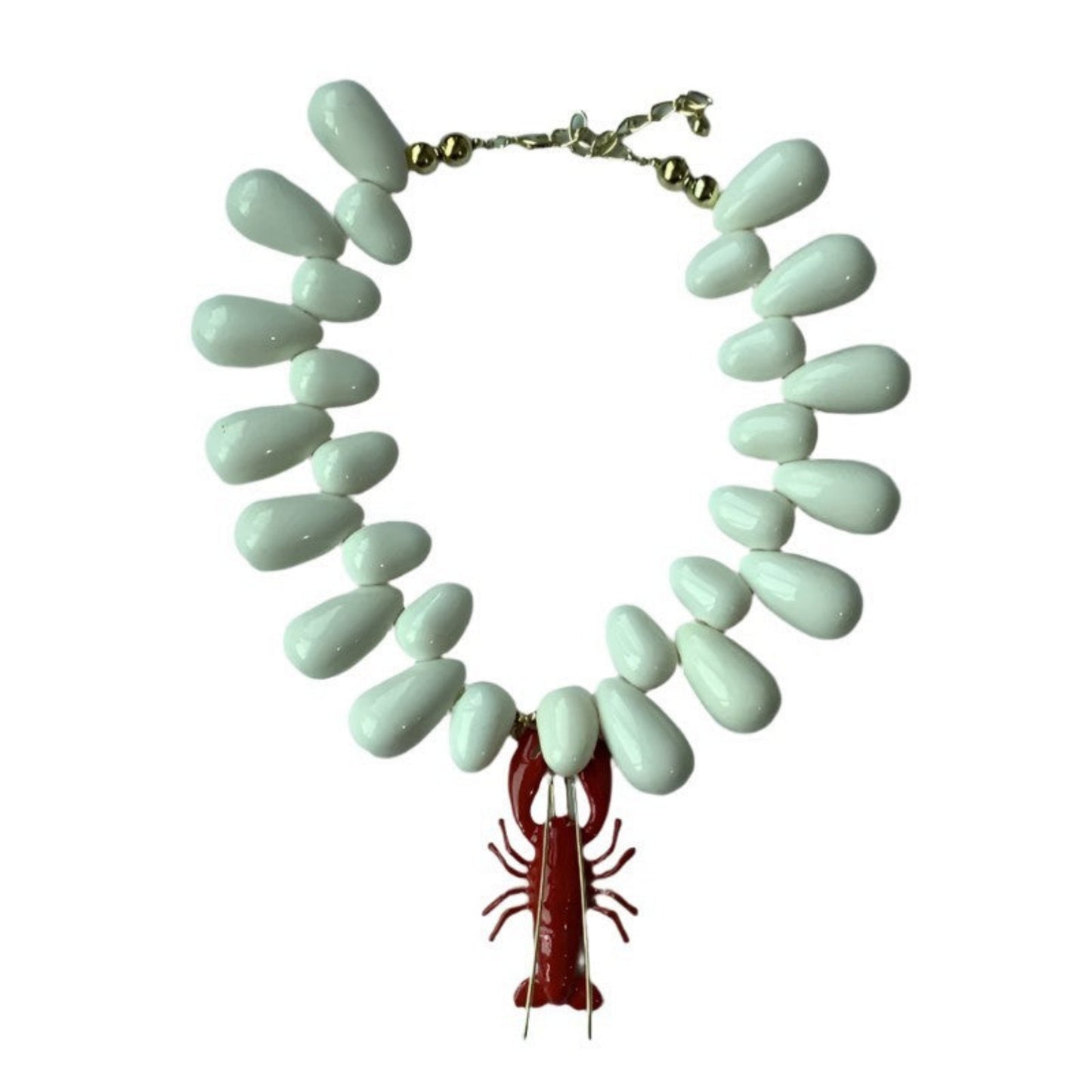 Necklace with light blue teardrop-shaped beads and a red lobster charm on a white background
Mystic Marine Necklace - Close-up detail of marine pendant design and gold chain finish
