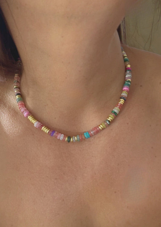 Memento Necklace - elegant pendant necklace by SIETE Y UNO
Close-up of a colorful beaded necklace on a person's neck.