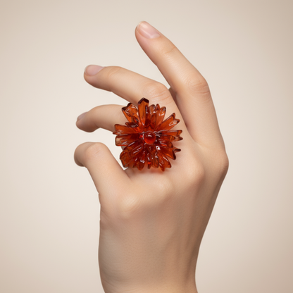 Hand wearing a red crystal flower ring against a beige background
Orange Spider Flower Ring worn - Model wearing orange flower statement ring
