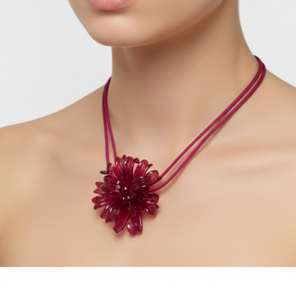 Fuchsia Spider Flower Necklace worn by model - handcrafted statement jewelry from Puerto Rico
Necklace with a large floral pendant worn by a model on a white background